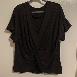 Black top with cute back detail!